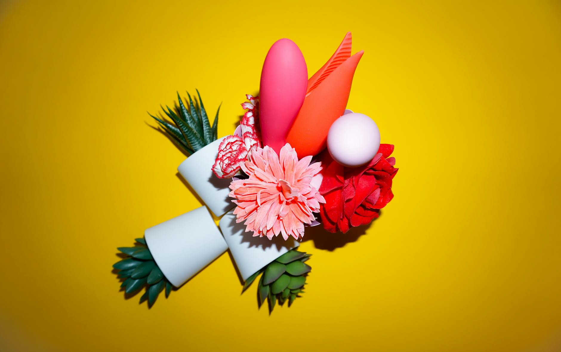 Yellow lemon vibrator surrounded by fresh lemons on a yellow background, symbolizing renewal and gentle pleasure